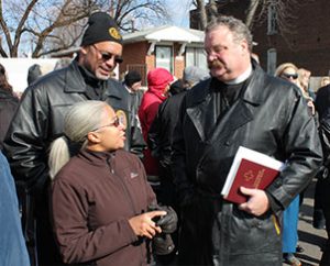 LCMS President Rev. Dr. Matthew C. Harrison, right, talks with Carmen and Eddie Gamble, residents of St. Louis’ College Hill neighborhood, during the March 20 groundbreaking there for Lutheran Housing Support’s “Nazareth Homes.” (LCMS Foundation/Blake Tilley)