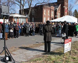 St. Louis Board of Aldermen President Lewis Reed, right center, offers congratulations during the March 20 groundbreaking for Lutheran Housing Support’s “Nazareth Homes” development in the College Hill neighborhood of St. Louis. About 200 people attended the event. (LCMS Foundation/Blake Tilley)