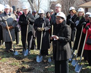 Nicole Ridley, foreground, thanks residents, city officials, supporters and volunteers during the March 20 groundbreaking for “Nazareth Homes” in St. Louis’ College Hill neighborhood.  Among those breaking ground were, from far left, LCMS Missouri District President Rev. Dr. Ray Mirly, Lutheran Church Extension Fund President and CEO Rich Robertson, and Synod President Rev. Dr. Matthew C. Harrison, fourth from left. (LCMS Foundation/Blake Tilley)