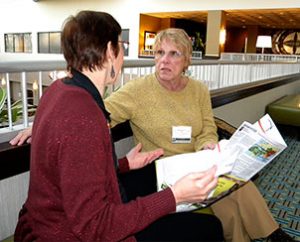 Dawn Mueller, left, of the Children's Christian Concern Society talks with Rita Nickel of Lutherans in Medical Missions during a break at the 2013 ALMA conference. (LCMS Communications/Paula Schlueter Ross)