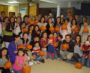 Student families at Texas A&M University show the pumpkins they carved during a 2012 fall harvest party at University Lutheran Chapel. The mix of students there is indicative of the growing number of Asian students at U.S. institutions of higher learning. (Paul Hoemann) 