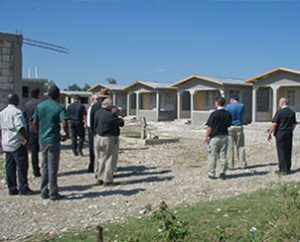 Haitians and Synod leaders view homes under construction in Leogane, in conjunction with the Jan. 14-15, 2012, dedication of three new Lutheran villages in Haiti. (LCMS Communications/Al Dowbnia)