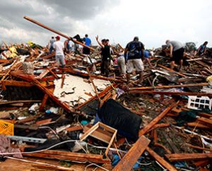 Workers look for victims under debris from the May 20 tornado that roared through the Oklahoma city suburbs, flattening entire neighborhoods. As of May 21, LCMS Disaster Response staff were assessing how the Synod can support the town's ongoing relief needs. (AP Photo/The Oklahoman, Paul Hellstern)