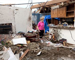 Linda Shoemake of Oklahoma City, Okla., looks through the living room of her home after the May 20 tornado took off the roof. Shoemake, a member of Trinity Lutheran Church in Norman, Okla., was not at home during the storm. (Dan Gill)