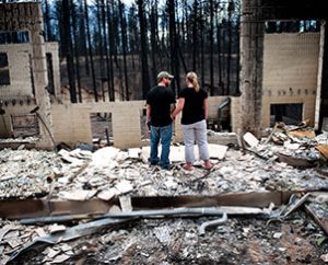 Jeremy and Kelly Beach look into the remains of their home off Ravine Drive on June 18 in Colorado Springs, Colo. Residents were allowed back into the area for a short time to view the properties that sustained the most damage from the fire. The Black Forest fire, the most destructive wildfire in Colorado history, has destroyed more than 500 homes and charred more than 22 square miles. (AP Photo/The Colorado Springs Gazette, Michael Ciaglo)