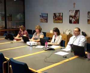 From left, LCMS Communications staff members Becky Cummings, Vicki Biggs and Adriane Dorr assist the Rev. Bart Day, executive director of the LCMS Office of National Mission, with the “Twitter chat” on marriage, June 19 at the Synod’s International Center in St. Louis.  (LCMS Communications/Melanie Ave)