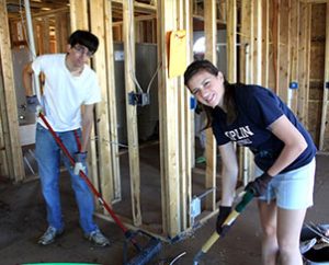 Two members of the youth group at Immanuel Lutheran Church, Joplin, Mo., sweep up after a day of work on a house being built by Habitat for Humanity, following the tornado that damaged the town in May 2011. The congregation's youth group raised $25,000 in donations from across the country to help them attend the LCMS Youth Gathering. (Stephanie Miller)