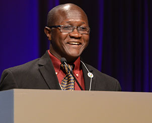 The Rev. James Kollie greets convention delegates on behalf of the Evangelical Lutheran Church of Liberia. (LCMS Communications)