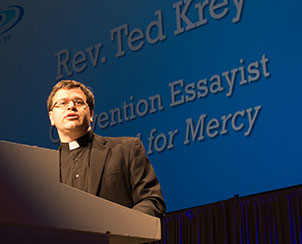 The Rev. Ted Krey delivers the third of four convention essays, “Baptized for Mercy,” Tuesday at the 65th Regular Convention. (LCMS Communications)