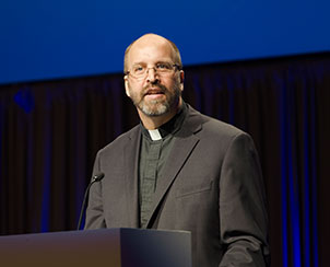 The Rev. Dr. Steven P. Mueller delivers the fourth and final convention essay, “Baptized for Life Together,” Wednesday at the 65th Regular Convention. (LCMS Communications)