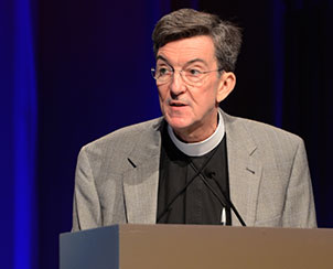 The Rev. Dr. Scott R. Murray, chair of the 2013 Theology and Church Relations floor committee, addresses the convention. (LCMS Communications)