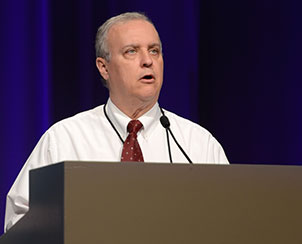 The Rev. David W. Totsky, secretary of the South Wisconsin District, reads Committee 7’s proposed amendments to Bylaws governing district operations to the delegates of the 65th Regular Convention of the LCMS. (LCMS Communications)