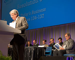 Floor Committee 6 Chairman Rev. John C. Wille presents an Administration and Finance resolution to the 65th Regular LCMS Convention, as members of the committee join him on the dais.