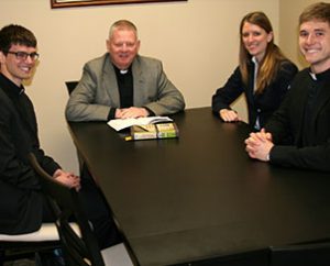 The Rev. John T. Pless meets with three of the four students at Concordia Theological Seminary who received awards for essays -- (from left) Aaron Hambleton, Faith (Fretham) Swenson and Scott Johnson. Jared DeBlieck is the other winning essayist. (Concordia Theological Seminary/Jayne Sheafer)