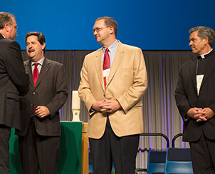 From left, Rev. Peter Prange of the Wisconsin Evangelical Lutheran Synod, Rev. Dr. Lawrence Welch of the Roman Catholic Archdiocese of St. Louis and Rev. David Wendel of the North American Lutheran Church are greeted by LCMS President Rev. Dr. Matthew C. Harrison. (LCMS Communications)