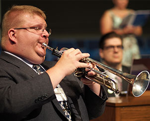 Matthew Janssen on trumpet and Cantor Phillip Magness on organ help lead the singing at a July 23 Matins service.