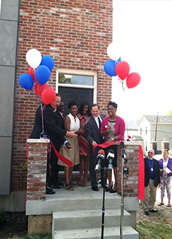 Officials cut the ribbon Aug. 23 to mark the completion of Lutheran Housing Support’s first of 20 homes in the Nazareth Homes development in St. Louis’ College Hill neighborhood. From left, LCMS President Rev. Dr. Matthew C. Harrison, St. Louis Board of Aldermen President Lewis Reed, St. Louis Alderwoman Dionne Flowers, St. Louis Treasurer Tishaura O. Jones, St. Louis Mayor Francis G. Slay and Nicole Ridley, chief executive officer of LCMS National Housing Support Corp., also known as Lutheran Housing Support. (LCMS Communications)