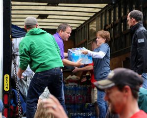 DCE Donna Patton of Peace with Christ Lutheran Church, Aurora, Colo., helps the Rev. Tim Runtsch, senior pastor of Redeemer Lutheran Church, Fort Collins, Colo., unload a case of bottled water Sept. 15. Members of Peace with Christ sent a truck with nearly 17,000 pounds of supplies to Fort Collins to help people who were displaced by floodwaters. (Redeemer Lutheran Church)