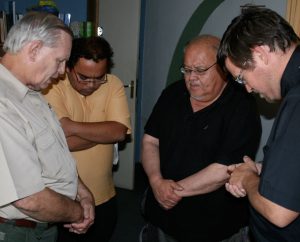 From left, LCMS Director of Disaster Response Rev. Glenn Merritt; ILC-Chile pastor the Rev. Alejandro Lopez; the Rev. Dr. Carlos Hernandez, director of LCMS Church and Community Engagement; and ILC-Chile President Rev. Cristian Rautenberg pray at the end of a meeting to plan the best ways to show mercy to those affected by the 2010 earthquake in Chile.