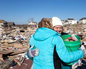 Shelly Goldammer smiles as Trudy Heren hugs her while they stand on what remains of Goldammer's house Monday, Nov. 18, 2013, in Washington, Ill. Goldammer and her family are members of Our Savior Lutheran Church in Washington. (LCMS Communications/Dan Gill)