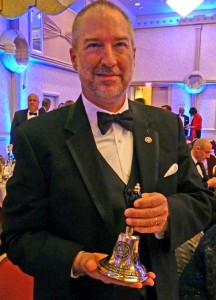 Thomas W. Wrege, principal of Trinity Lutheran School, Utica, Mich., holds the teachers bell presented to him at the Oct. 25 awards banquet for the “2013 National Distinguished Principals.” (Thomas W. Wrege)