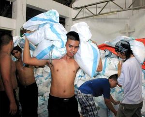 Volunteers load food packs bound for Christ Lutheran Church in Mahayag, Albuera, Leyte, at the compound of Our Savior Lutheran Church in Matina Aplaya, Davao City, Philippines, in late November. The food packs — purchased with LCMS disaster dollars — were distributed to families in Mahayag affected by Typhoon Haiyan. (LCP Disaster Response/JC Valeriano)