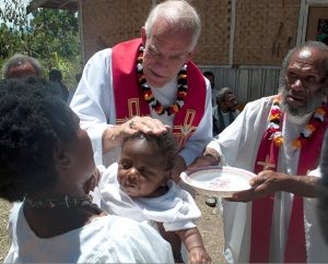 The Rev. Ron Rall, pastor of Timothy Lutheran Church in St. Louis and former missionary to Papua New Guinea, baptizes a baby on Aug. 26, 2011, during a visit to that country. At right is Bishop Philipo, a regional bishop of the Gutnius Lutheran Church, an LCMS partner church. Four congregations came together to celebrate 52 baptisms and 20 confirmations that day. Gifts to the Synod's Global Mission Fund are used to share the Gospel through missionaries and partner churches worldwide. (LCMS)