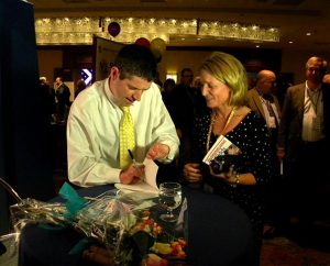 John O’Leary, a keynote speaker for LCEF’s 2013 Fall Leadership Conference, signs a participant’s copy of his parents’ book about the family’s experiences around John’s suffering and healing from what were considered fatal burns when he was 11 years old. In his keynote, O’Leary credited God’s gift of grace — echoing the conference theme — for helping him survive and thrive. (LCMS Communications/Joe Isenhower Jr.)