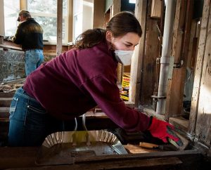 Kelsey Bergquist, a student at South Dakota State University, helps gut the interior of a home damaged by September flooding on Jan. 8, 2014, in Lyons, Colo. Bergquist is one of seven students who traveled to the hard-hit area to do volunteer relief work. (LCMS Communications/Erik M. Lunsford)