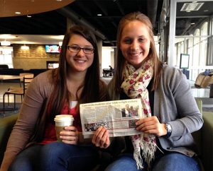 Rebecca Monnier, left, and Louisa Mehl hold a copy of the Lincoln Journal Star featuring a story about their 2012 trek to Tanzania and how they raised more than $50,600 in donations for the Lutheran Malaria Initiative. Monnier and Mehl are seniors at Concordia University, Nebraska, in Seward, Neb. (Dionne Lovstad-Jones)