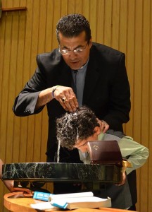 The Rev. Karim Baidaoui, missionary at-large to Muslim people in the LCMS Texas District, baptizes a young boy. Baldaoui heads the ministry in Dallas known as Disciples of the Way. (Disciples of the Way)