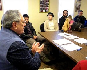 The Rev. Dr. Allan R. Buckman explains the ministry of Christian Friends of New Americans to the new missionary families during their orientation visit to that agency's St. Louis office Feb. 10. (LCMS Communications/Joe Isenhower Jr.)