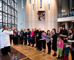 The Rev. Randall Golter, executive director of the LCMS Office of International Mission, leads prayer during the Rite of Sending for missionaries on Feb. 14, 2014, at the LCMS International Center in St. Louis. (LCMS Communications/Erik M. Lunsford)