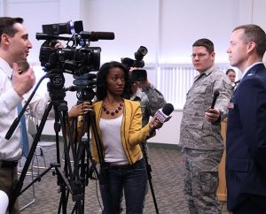 Reporters from local news stations ask questions of Captain Michael Frese, the only LCMS chaplain to receive the award for service in Afghanistan. (Steve Blakey, BB Design Inc.)