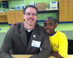 The Rev. Steve Schave sits with Remi, a student at John P. Park Elementary School whom Schave tutored and mentored while serving as pastor of St. Paul Lutheran Church, Cincinnati. (St. Paul Lutheran Church circa 2012)