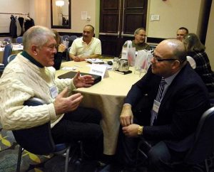 The Rev. Thomas Going of the Japanese Mission Society, Columbus, Ind. (left), and the Rev. Alex Merlo of the Northern Illinois District discuss best resources, ideas and trends during a small-group discussion at the annual conference of the Association of Lutheran Mission Agencies. (LCMS Communications/Paula Schlueter Ross)