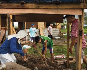With the help of LCMS disaster dollars, Cash-for-Work builders construct a well (foreground) and parsonage (rear) next to Christ Lutheran Church in Mahayag, Philippines (LCMS Communications/Erik M. Lunsford)