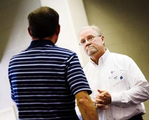 The Rev. John Fale, right, associate executive director of LCMS Mercy Operations, talks with one of 30 participants at LCMS Specialized Pastoral Ministry’s first Regional Educational Event, Feb. 24-26 in St. Louis. (LCMS Communications/Erik M. Lunsford)