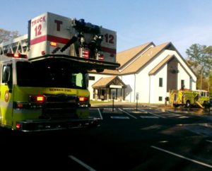 A local firefighting unit responds to the April 20 two-alarm fire at Trinity Lutheran Church, Richmond, Va., that caused no injuries, but resulted in limited destruction and considerable smoke and water damage. (WTVR.com)