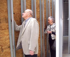 Chuck and Kathy Buchtrup, members of Shepherd of the Hills Lutheran Church in Crossville, Tenn., write their favorite Bible verses on interior studs for the building addition there during a “holy graffiti” event when Laborers For Christ workers hosted a luncheon for the congregation. (Lutheran Church Extension Fund)