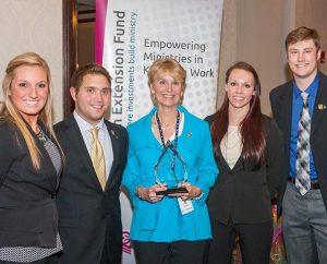 Teammates from Concordia University, St. Paul, Minn., display their first-place trophy at the third annual – and most competitive to date– Lutheran Church Extension Fund National Student Marketing Competition, April 4, at the LCMS International Center in St. Louis. The team included, from left, Amanda Konetchy, Thomas Streed, faculty advisor Dr. Nancy Harrower, Kayla Koenecke and Matt Buhmann. (Lutheran Church Extension Fund)