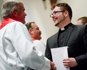 Concordia Seminary, St. Louis, President Rev. Dr. Dale Meyer congratulates the Rev. Andrew Rosse on receiving his first call — to Christ the King Lutheran Church in Natchitoches, La. In the background is LCMS President Rev. Dr. Matthew C. Harrison. (LCMS Communications/Erik M. Lunsford)