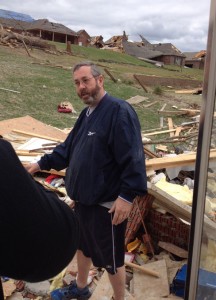 Jimmy Womack, a member of Shepherd of Peace Lutheran Church in Maumelle, Ark., shows what is left of his home — a pile of rubble — after an EF4 tornado hit Mayflower, Ark., April 27. He, his wife, Mary, and their 3-year-old daughter survived by hovering in a bedroom closet. The family was not injured but their home was destroyed. (John Gierke)