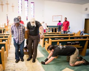 Volunteers and pastors from several Lutheran congregations help remove the organ, carpet and pews from the flooded sanctuary of St. Matthew Lutheran Church in Pensacola, Fla., on May 3. The church was one of four LCMS churches in the area that flooded April 30 during the highest rainfall ever recorded in the port city. More than 3,000 homes flooded and most of the homeowners did not have flood insurance.  (LCMS Communications/Erik M. Lunsford)