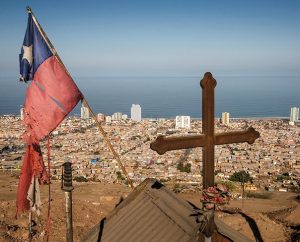 A roadside memorial with a cross and a tattered Chilean flag overlook Iquique, Chile, after a powerful earthquake struck April 1 about 95 kilometers to the northwest. The quake led to several thousand homes being condemned and severely damaged 10,000 others. (LCMS Communications/Erik M. Lunsford)