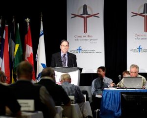The Rev. Dr. Robert Bugbee speaks to those attending the June 6-9 Lutheran Church—Canada convention in Vancouver, British Columbia, just after delegates elected him by acclamation to his third three-year term as the church body’s president. (Gabor Gasztonyi)