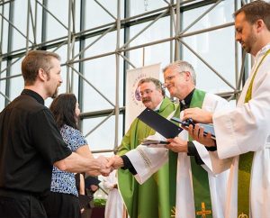 Missionary Michael Ritzman, left, shakes hands with the Rev. Randy Golter, executive director of the LCMS Office of International Mission (OIM), during the June 27 Service of Sending for new missionaries at the International Center chapel. Also pictured are Ritzman's wife, Beth, LCMS President Rev. Dr. Matthew C. Harrison and the Rev. Dr. Edward Grimenstein, OIM’s associate executive director. The Ritzmans will serve in Papua New Guinea. (LCMS/Erik M. Lunsford)