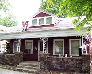 Working for the LCMS National Housing Support Corporation, members of LCEF’s Laborers For Christ and volunteers paint an “at risk” house in Fort Wayne, Ind., one of seven properties where low-income or elderly homeowners lack resources to address needed maintenance. Each home is near one of three LCMS churches also participating in the Helping Hand project. (Lutheran Church Extension Fund) 