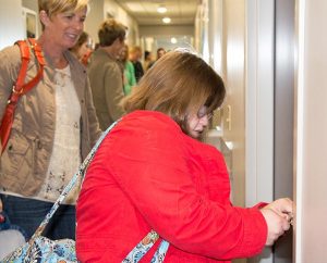 Mary Cate Neff opens the door to her new dorm room for herself and her mother, Elizabeth Neff. (Terri Breese/Bethesda Lutheran Communities)