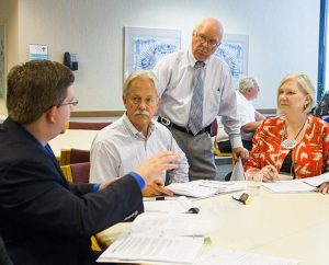 Allen Helms, standing, senior vice-president for Gift-Planning Services for the LCMS Foundation, meets with several participants at a Foundation “Lifetime Plan for Giving” seminar in St. Louis. From left, they are Daniel Jenkins, vice-president of Institutional Advancement for Concordia College, Selma, Ala.; Robert Wirth, gift-planning counselor for the LCMS Eastern District; and Teri Rice, development director for the LCMS Northern Illinois District. (LCMS Foundation/Adrian Bordeleau)